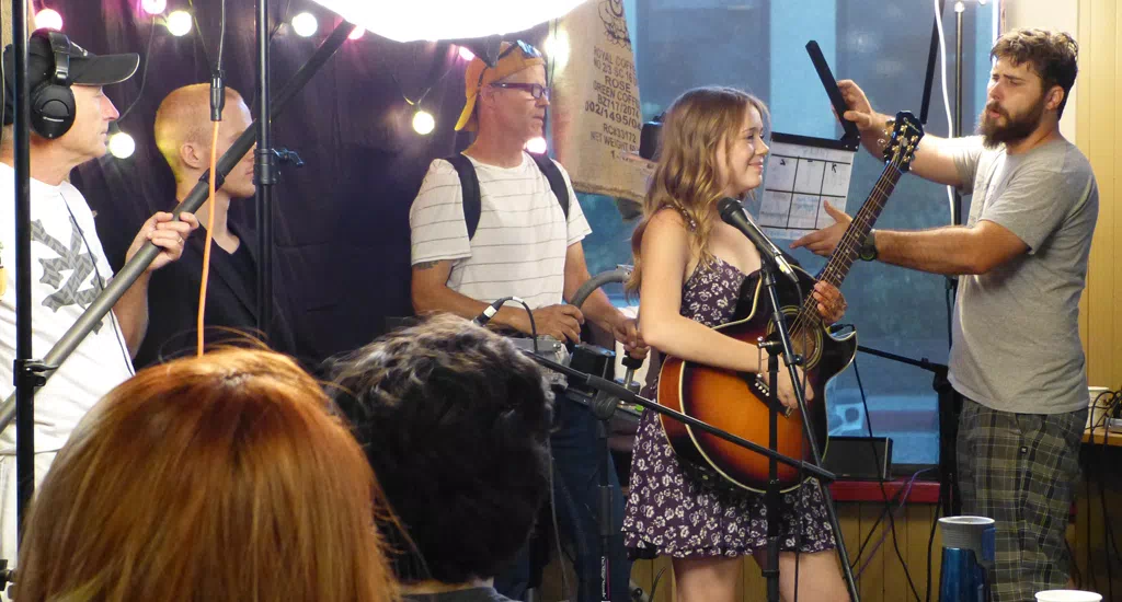 The movie TODAY on location at Carolines Coffee Roasters in Grass Valley, California - Brandan Brooks on camera capturing Haley Pritchard singing and playing guitar.